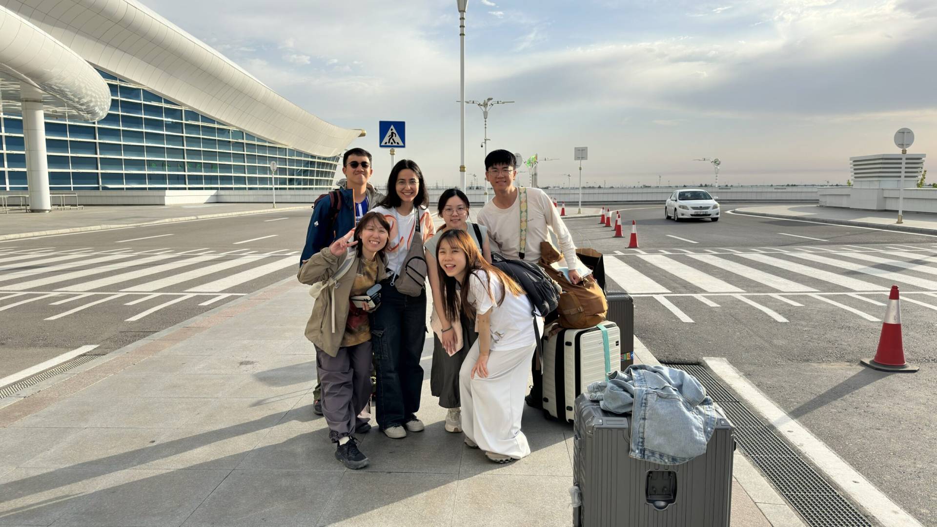3 Day Turkmenistan Tour from Ashgabat: Darvaza & Night Train to Bukhara Five Hong Kong tourists with their guide Aiza at Ashgabat International Airport before their flight home after touring Turkmenistan