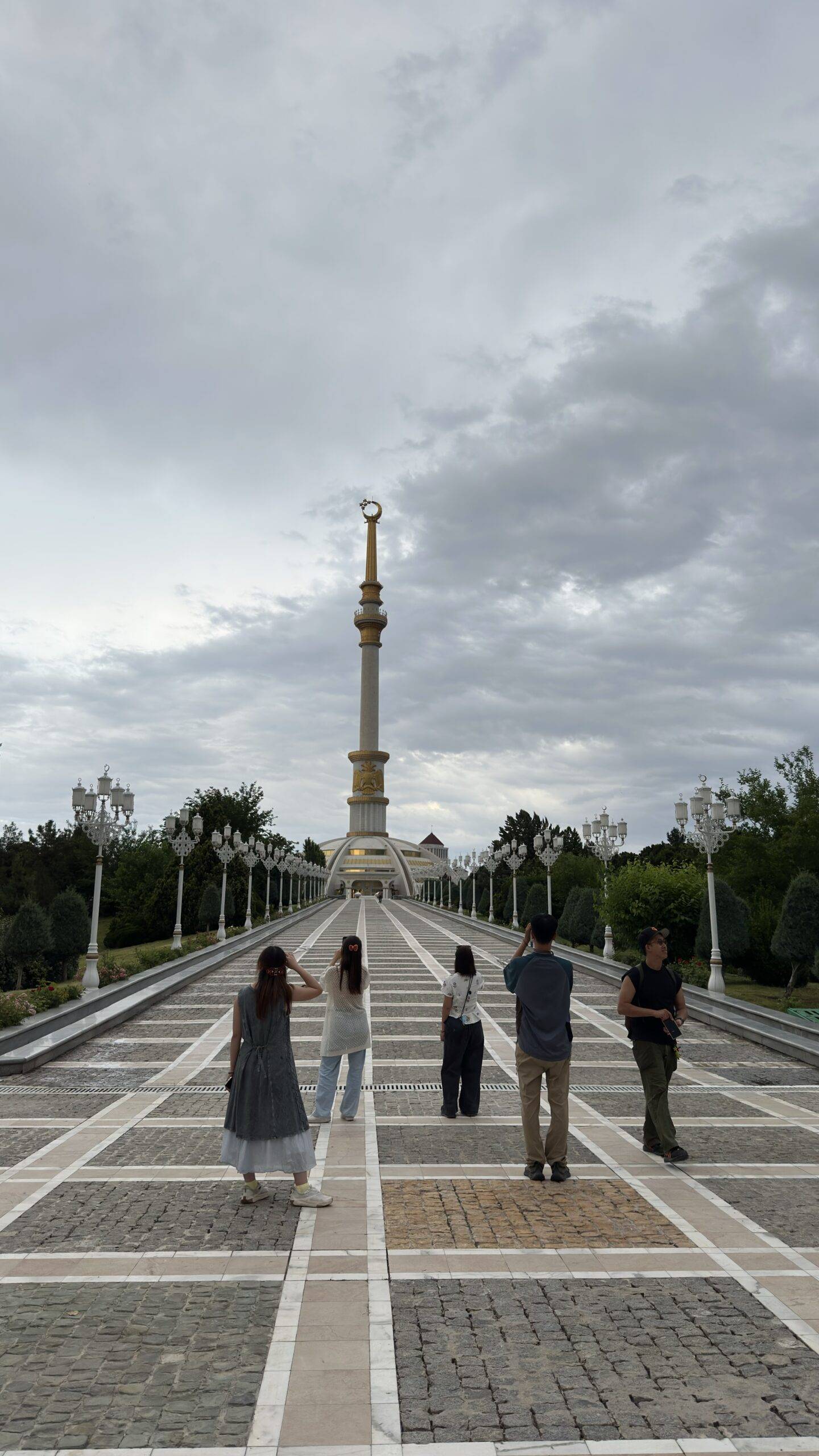 3 Day Turkmenistan Tour from Ashgabat: Darvaza & Night Train to Bukhara Hong Kong tourists walking along the grand avenue leading to the Independence Monument in Ashgabat, Turkmenistan