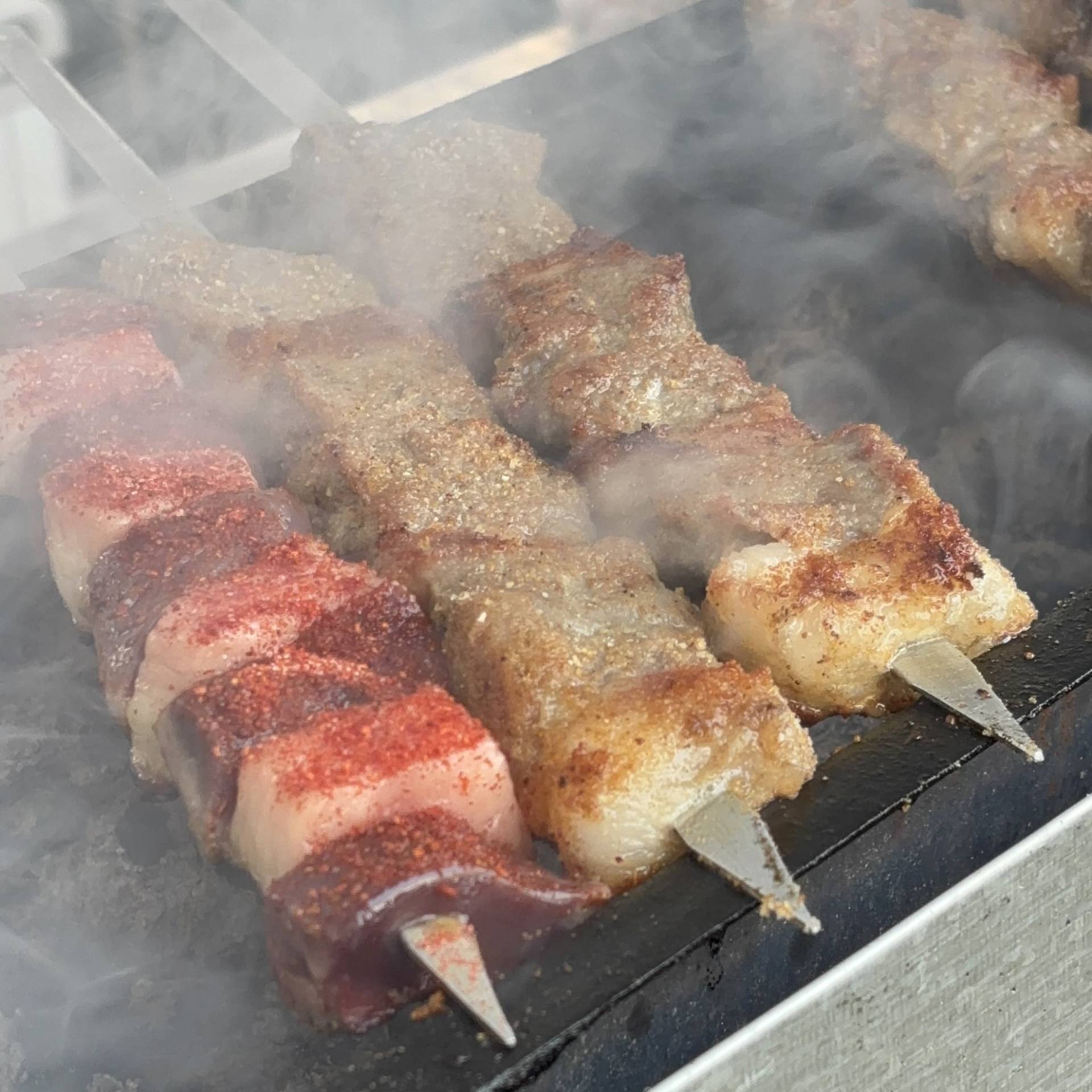 2 Day Turkmenistan Tour from Khiva to Darvaza Gas Crater Turkmen lamb shashlik and liver with fat grilling on skewers over smoky charcoal, traditional street food in Turkmenistan.