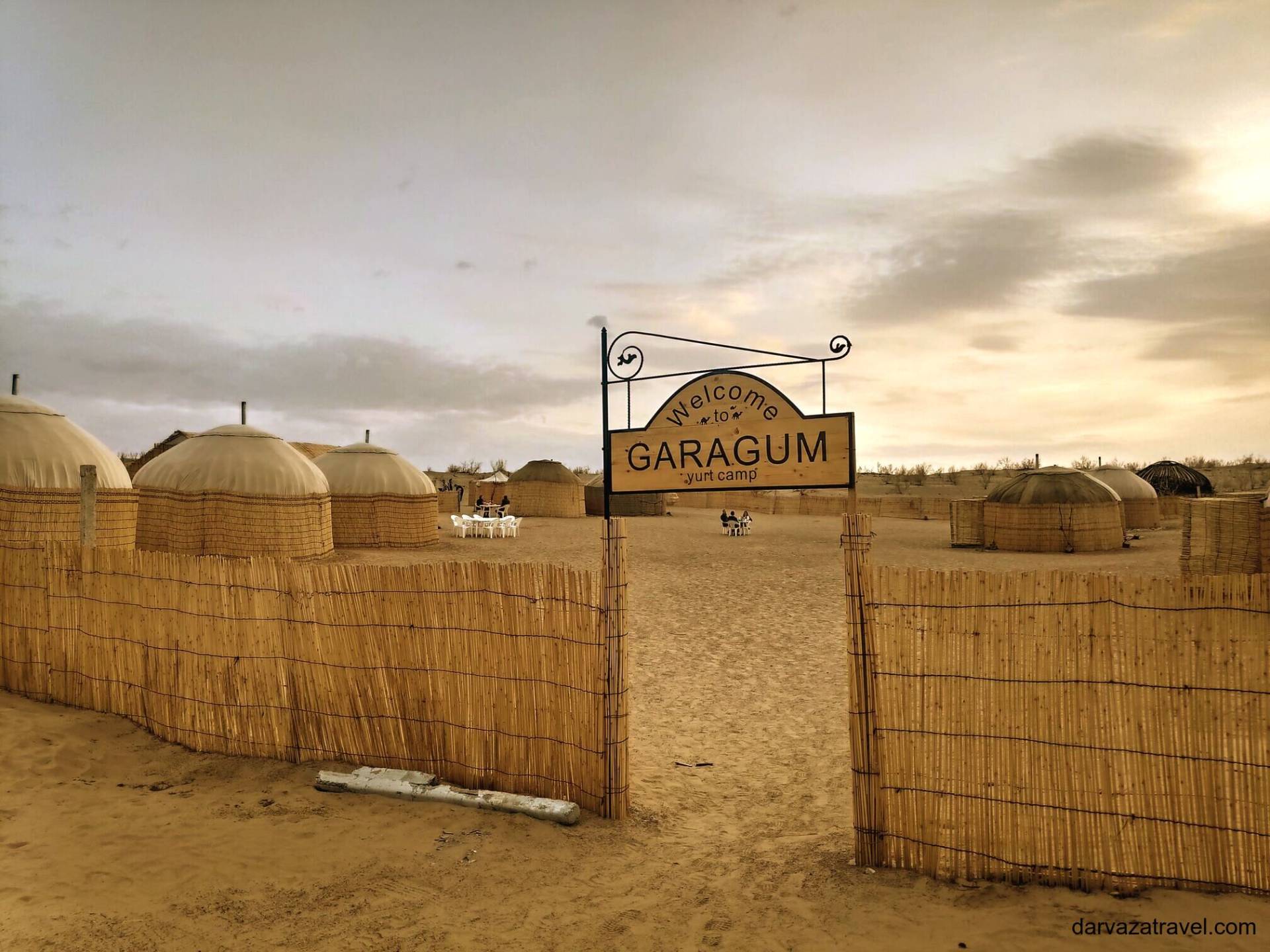 Darvaza Yurt Camp Entrance gate of Garagum Yurt Camp with reed fencing and traditional yurts