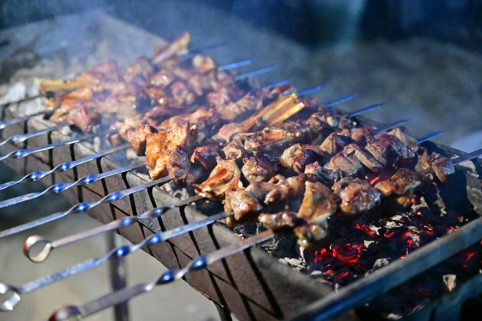 Darvaza Yurt Camp Traditional barbecue shashlik on skewers prepared for tourists at Darvaza Gas Crater camp in Turkmenistan