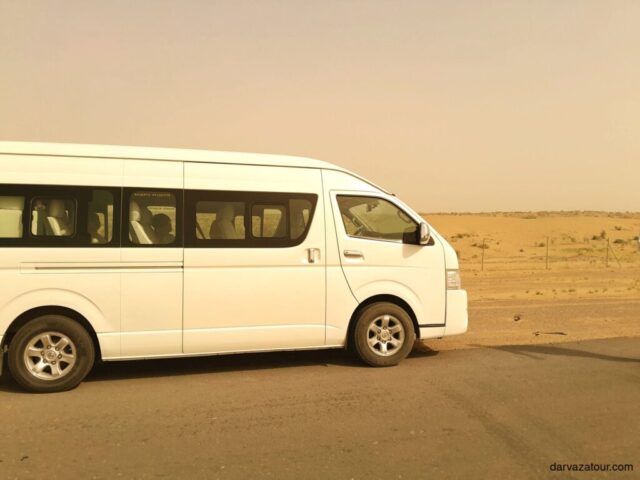 Turkmenistan travel tour van driving through Karakum desert landscape - transportation for Darvaza gas crater excursion in Turkmenistan