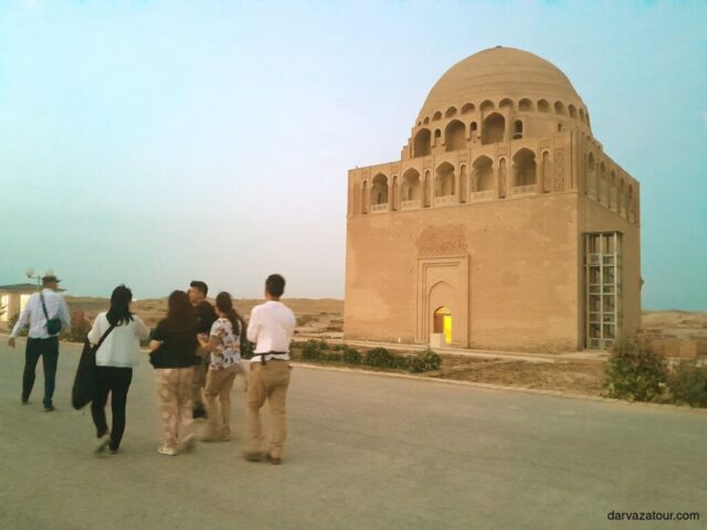 Tourists visiting the 12th century Sultan Sanjar Mausoleum in Ancient Merv, Turkmenistan - historical UNESCO World Heritage site in Mary region