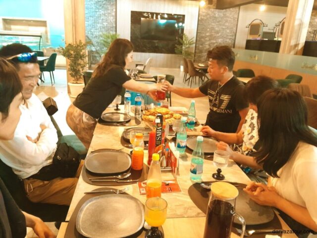 Traditional Japanese restaurant dinner with Turkmenistan tour group enjoying cultural cuisine experience in Ashgabat - Darvaza Tour culinary excursion