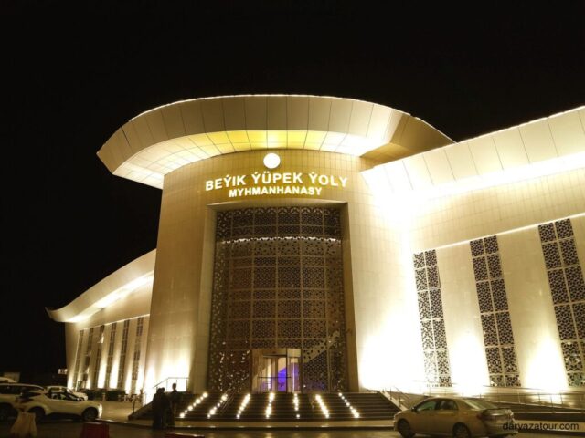 Illuminated entrance of Beyik Yupek Yoly (Great Silk Road) Hotel in Turkmenbashi, Turkmenistan featuring modern architecture and elegant design