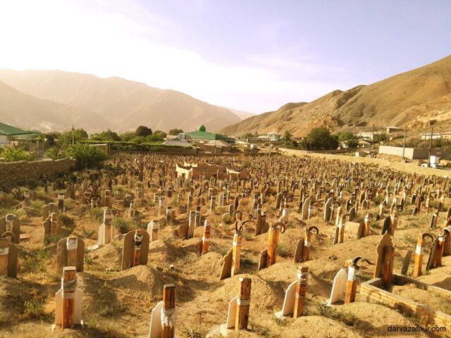 Historic Nokhur cemetery with traditional horn-decorated graves in Turkmenistan mountains - unique cultural heritage site and must-visit attraction during Turkmenistan tours. Ancient burial traditions preserved in this remote mountain village showcase authentic local customs dating back centuries.