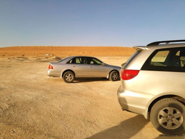 Vehicles traveling through Karakum Desert in Turkmenistan on the way to Darvaza Gas Crater Turkmen desert expedition