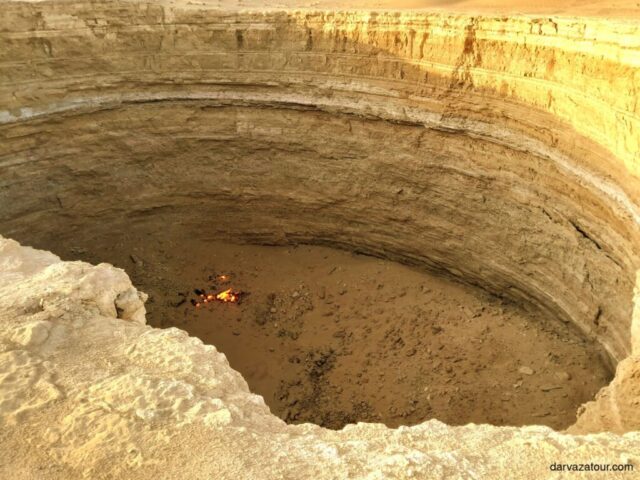Darvaza mud crater in Turkmenistan - a natural attraction near the Gates of Hell. A unique geological formation in the Karakum Desert, a popular destination for tourists on a tour to Turkmenistan.