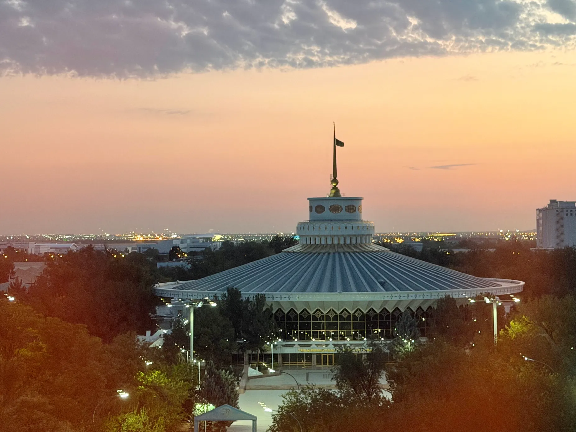 Ashgabat State Circus at Sunset Ashgabat State Circus building illuminated during sunset with the Turkmenistan flag above the circular roof