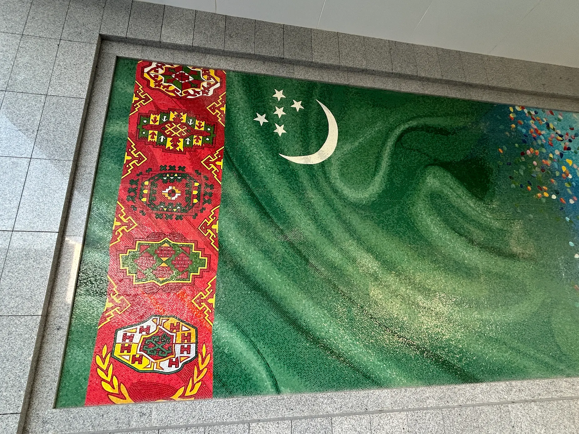 Turkmenistan national flag design with traditional carpet patterns, crescent moon and five stars displayed in Ashgabat