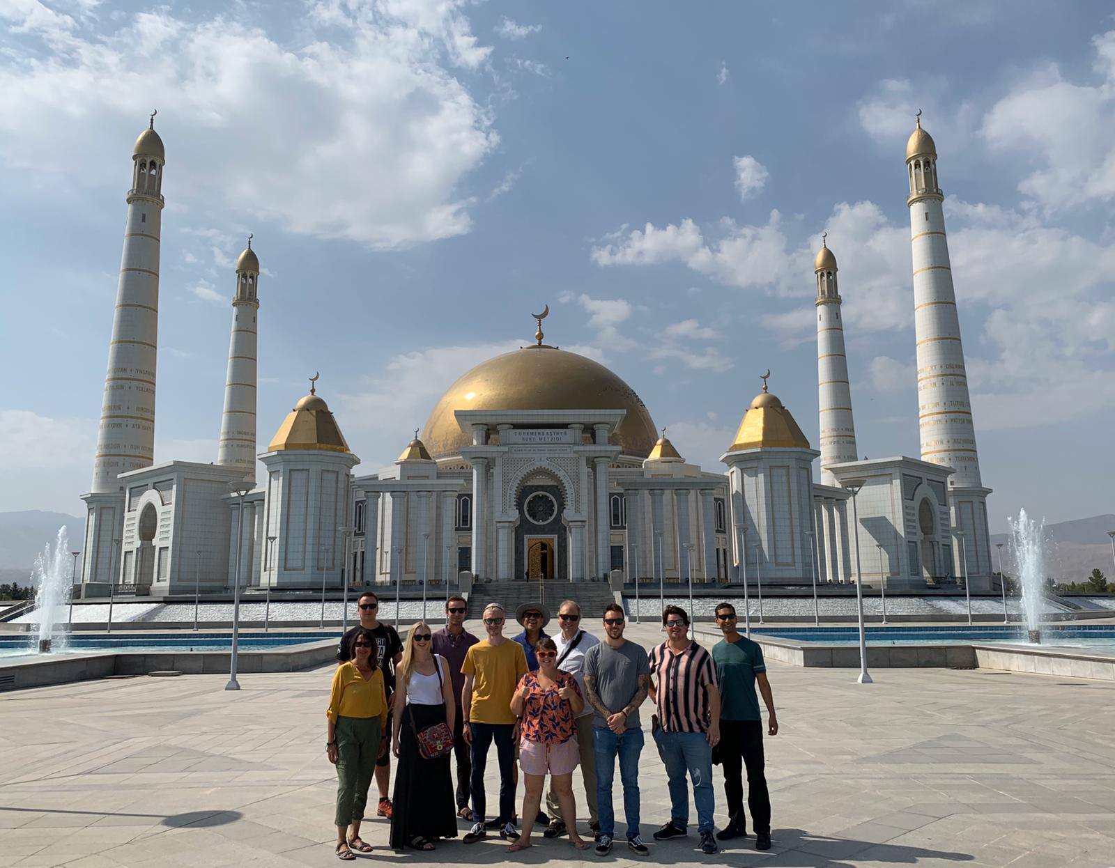 Tour group from different countries visiting the Turkmenbashi Ruhy Mosque in Ashgabat, Turkmenistan the largest mosque in Central Asia, famous for its golden domes and four minarets.
