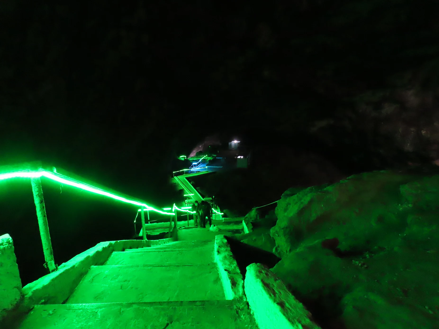Kow-Ata Underground Lake and Cave Illuminated staircase descending deep into Kow-Ata Cave toward the warm underground lake in Turkmenistan