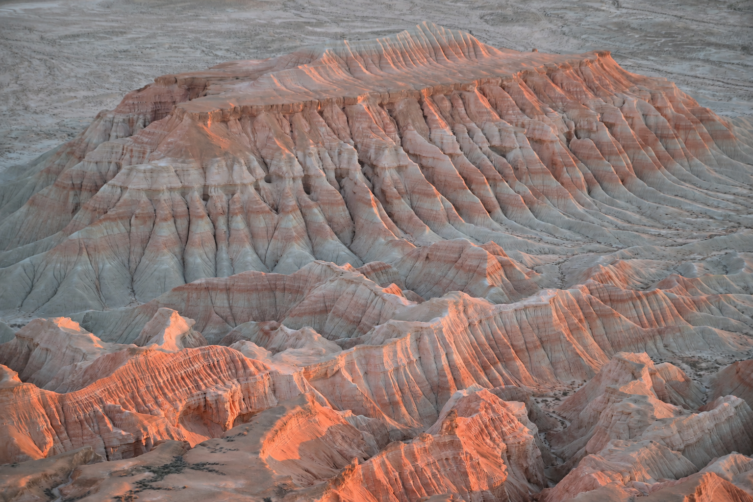 Yangikala Canyon in summer heat, stunning red and white cliffs in Turkmenistan desert near Caspian Sea and Kazakhstan border