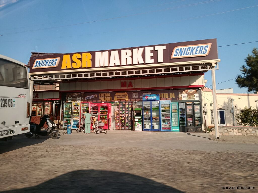 ASR Market in Uzbekistan with colorful drink stands and local people near Bukhara
