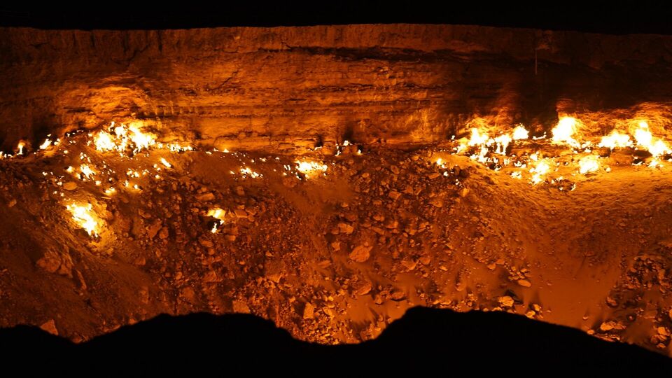 Inside view of Darvaza Gas Crater in Turkmenistan, burning flames lighting up the Gates of Hell at night