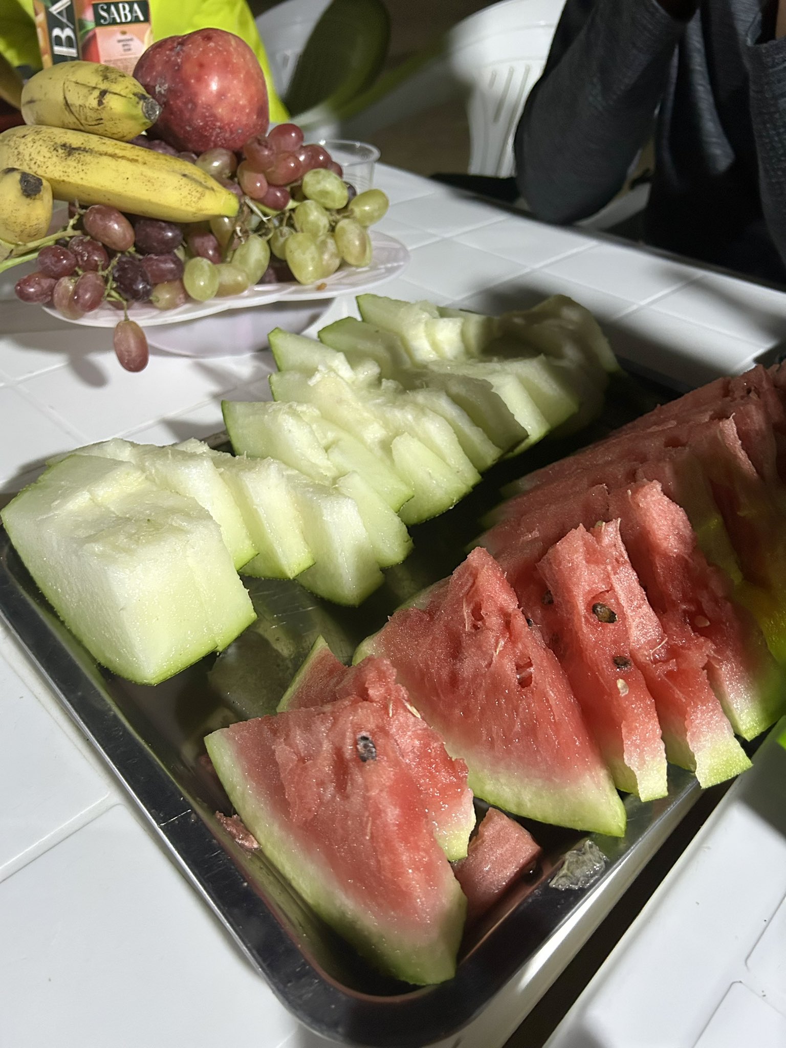Statue of a warrior with bow and arrows in Ashgabat, Turkmenistan, with white marble buildings in the background.