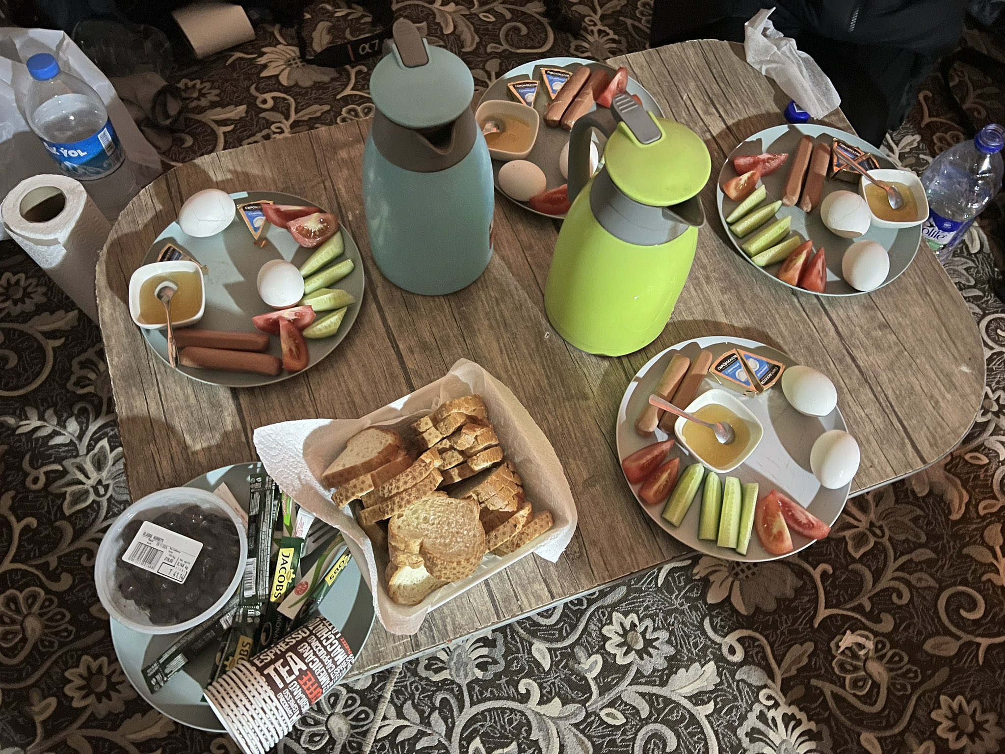 Darvaza Tour Company breakfast served in a yurt near the Darvaza Gas Crater with eggs, sausages, bread, honey, tea and coffee for tourists.