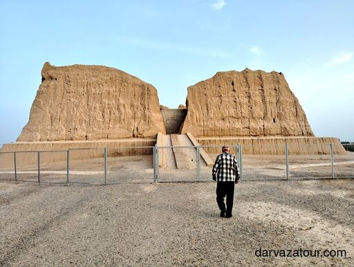 White marble buildings and tree-lined avenue in Ashgabat, Turkmenistan, at sunset.