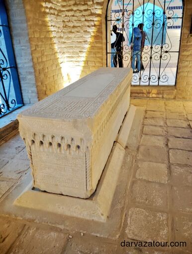 Ancient stone sarcophagus with Arabic inscriptions inside a mausoleum in Merv, Turkmenistan – sacred resting place of a local saint, UNESCO World Heritage site