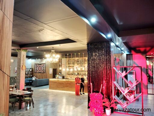 White marble buildings and tree-lined avenue in Ashgabat, Turkmenistan, at sunset.