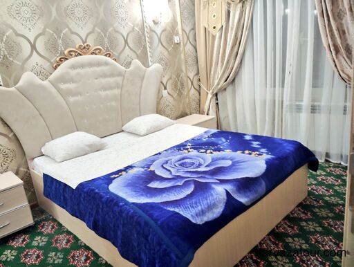 Comfortable double bed at Mizan Hotel in Ashgabat, Turkmenistan