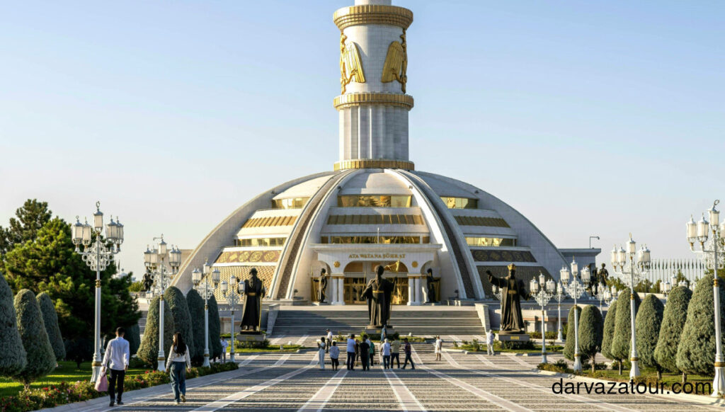Monument of Neutrality in Ashgabat, Turkmenistan with tourists walking on the square