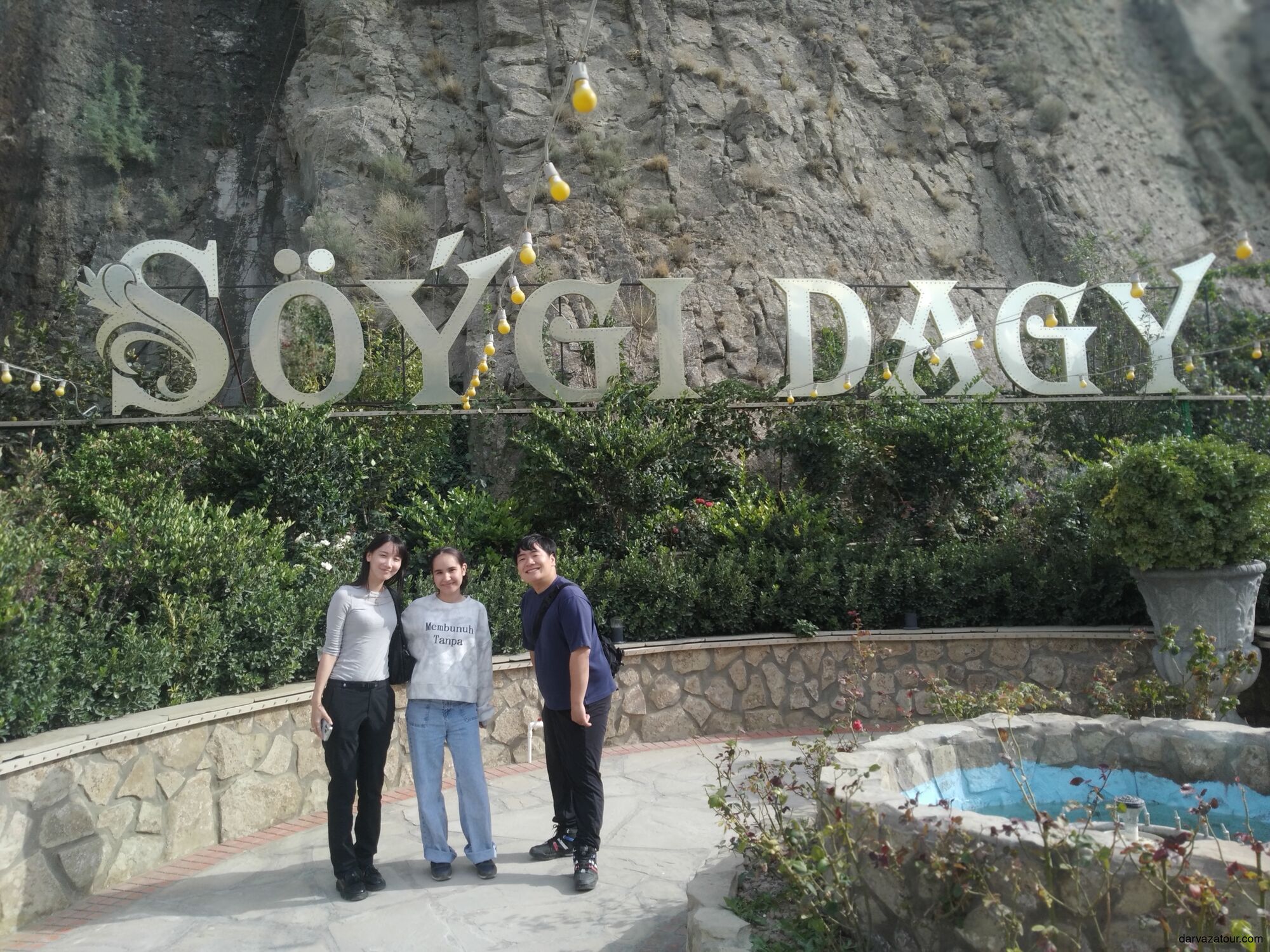 Guide Gozel with Japanese travelers Ryoma and his wife visiting Söýgi Dagy (Love Mountain) in Turkmenistan — a popular romantic viewpoint near Ashgabat.
