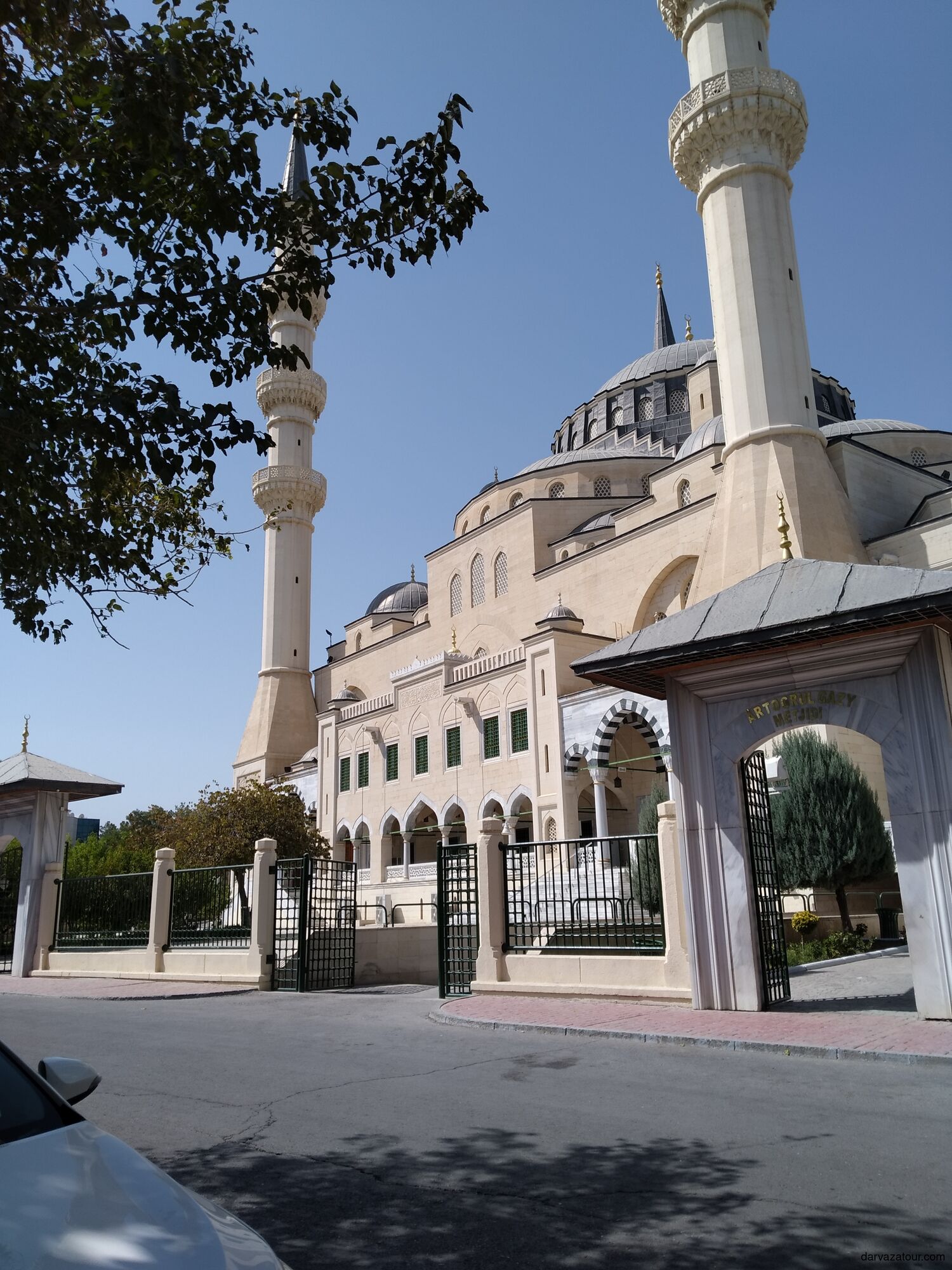 Ertugrul Gazi Mosque in Ashgabat, Turkmenistan — a grand Ottoman-style mosque inspired by Istanbul’s Hagia Sophia, featuring four tall minarets and elegant domes under the clear blue sky.
