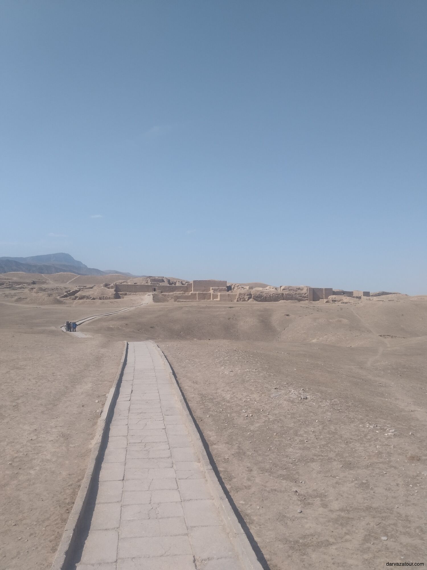Ancient Nisa ruins in Turkmenistan — UNESCO World Heritage site near Ashgabat with tourists walking along the path to the archaeological remains.