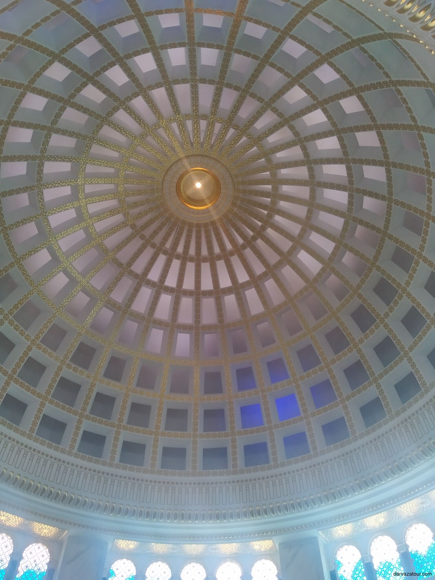 Interior dome of Ertugrul Gazi Mosque in Ashgabat, Turkmenistan — beautifully decorated with golden patterns and geometric design inspired by Ottoman architecture.