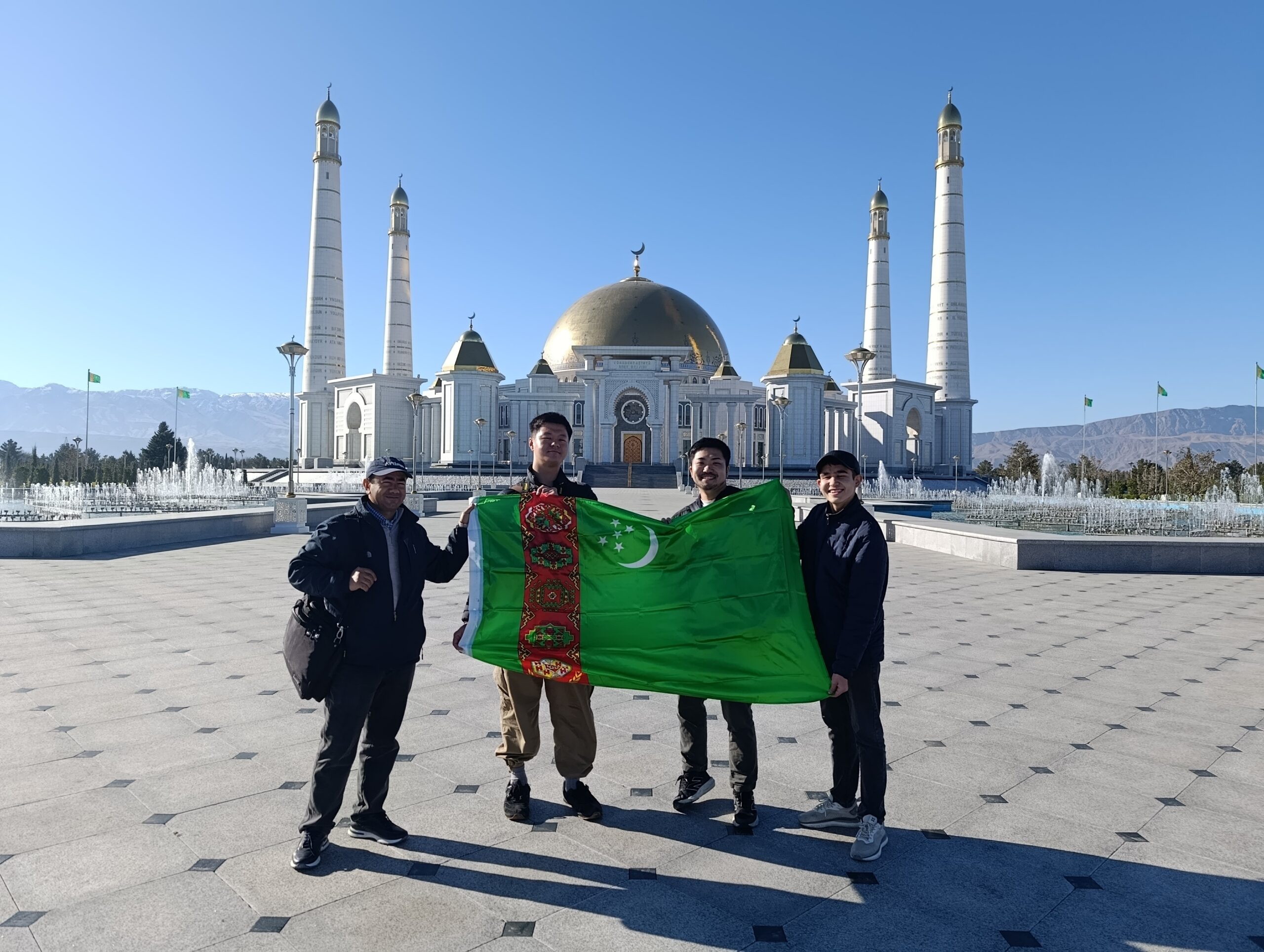 Japanese Tourists at Turkmenbashi Ruhy Mosque Japanese tourists and their guide holding the Turkmenistan flag in front of Turkmenbashi Ruhy Mosque
