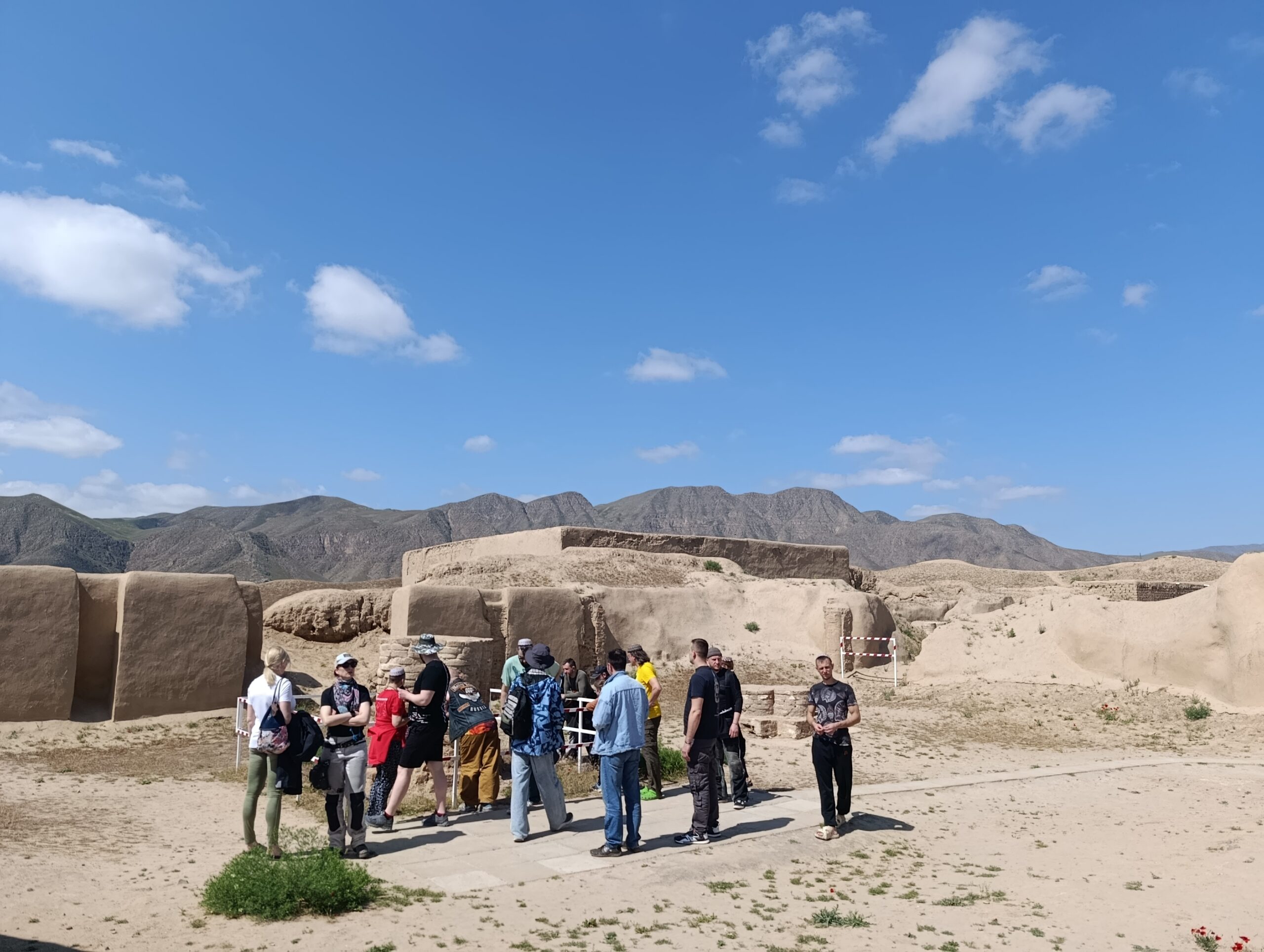 Local guide telling a group of travellers about the history of Ancient Nisa below the Kopetdag Mountains