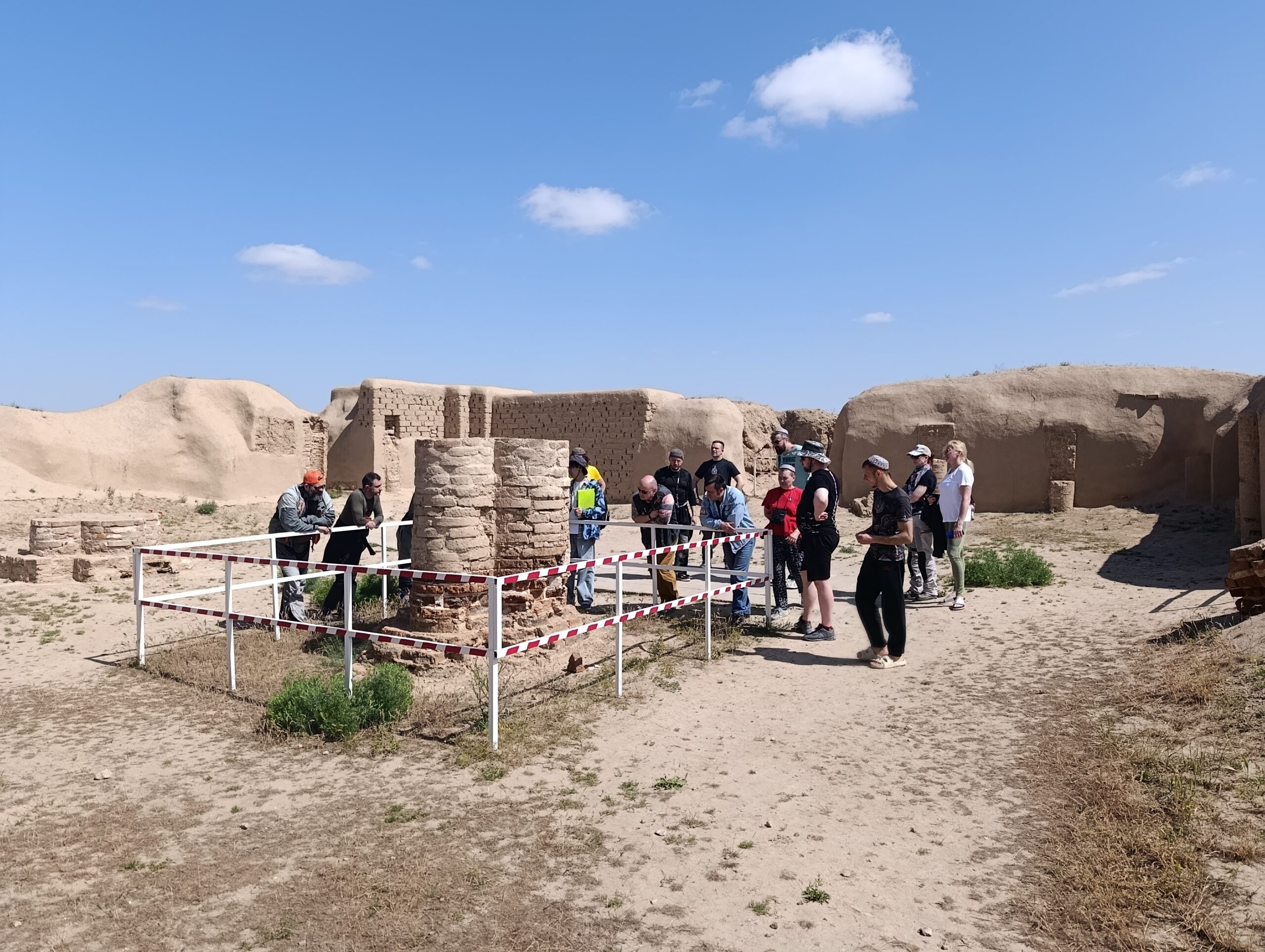 Archaeological Remains at Ancient Nisa Tourists examining protected ancient brick remains inside the Ancient Nisa archaeological site in Turkmenistan