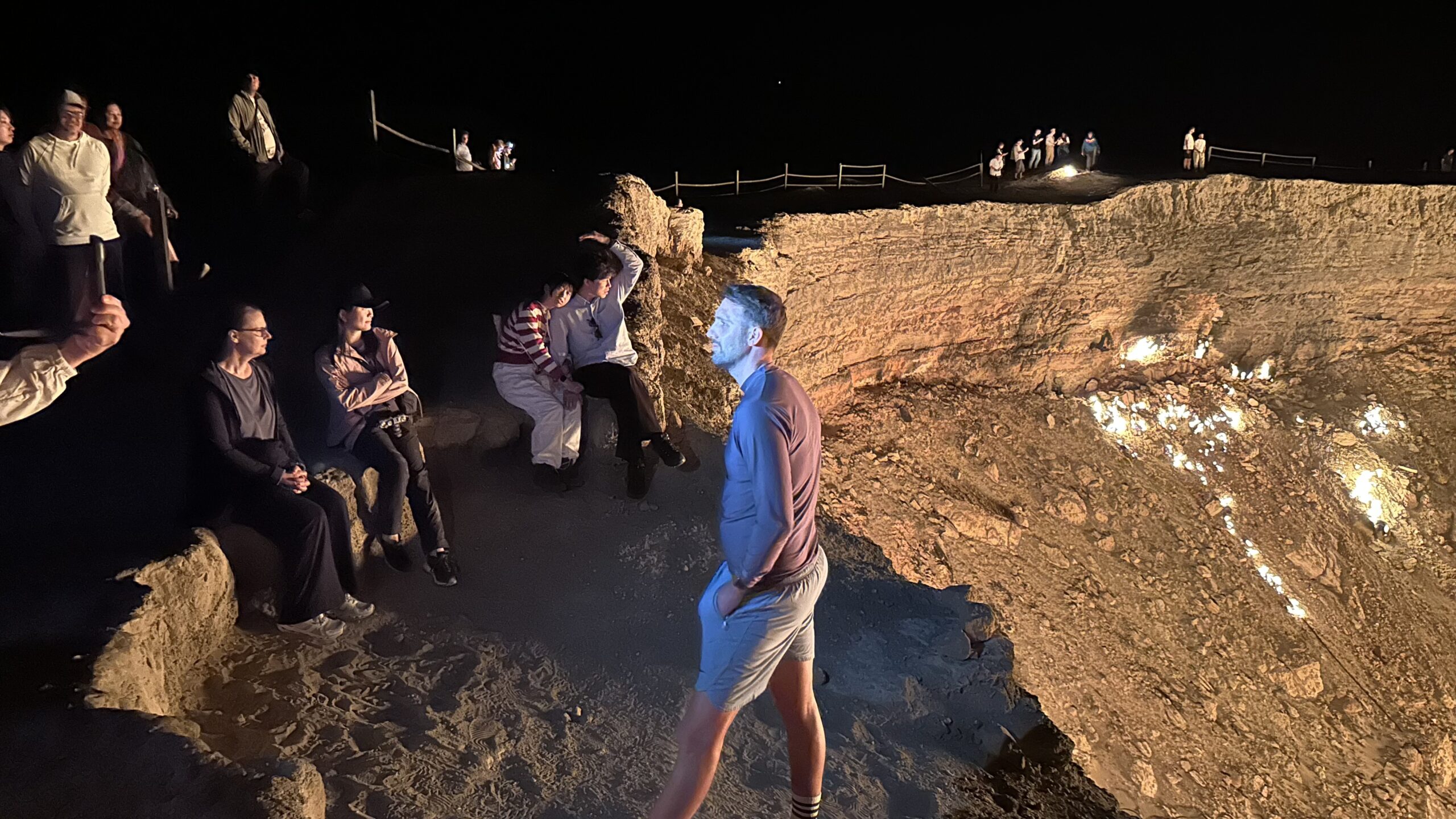 International Tourists at Darvaza Gas Crater, Turkmenistan Tourists from around the world watching the burning Darvaza Gas Crater at night in Turkmenistan