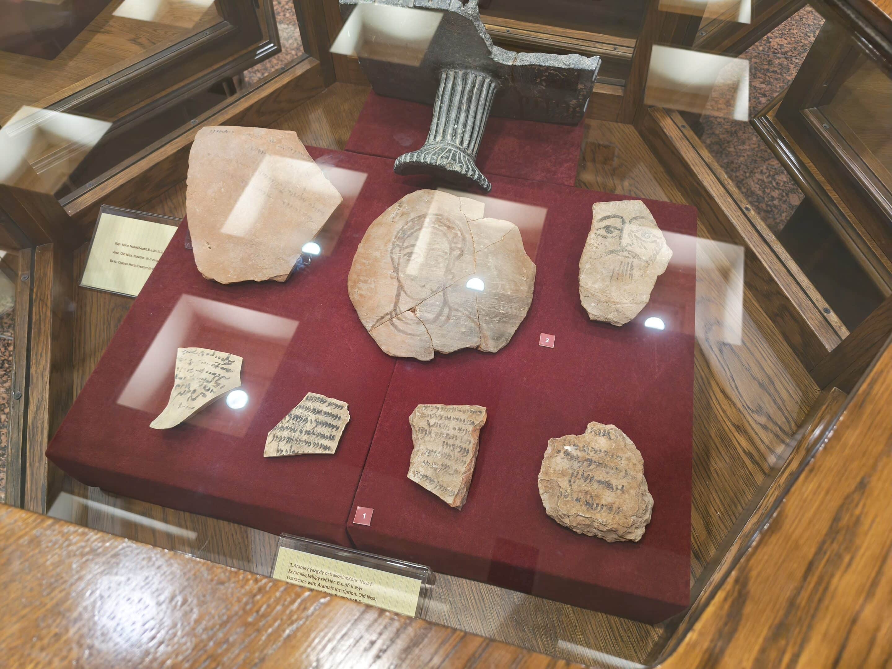 Inscribed pottery fragments (ostraca) from Ancient Nisa displayed in a museum case in Turkmenistan