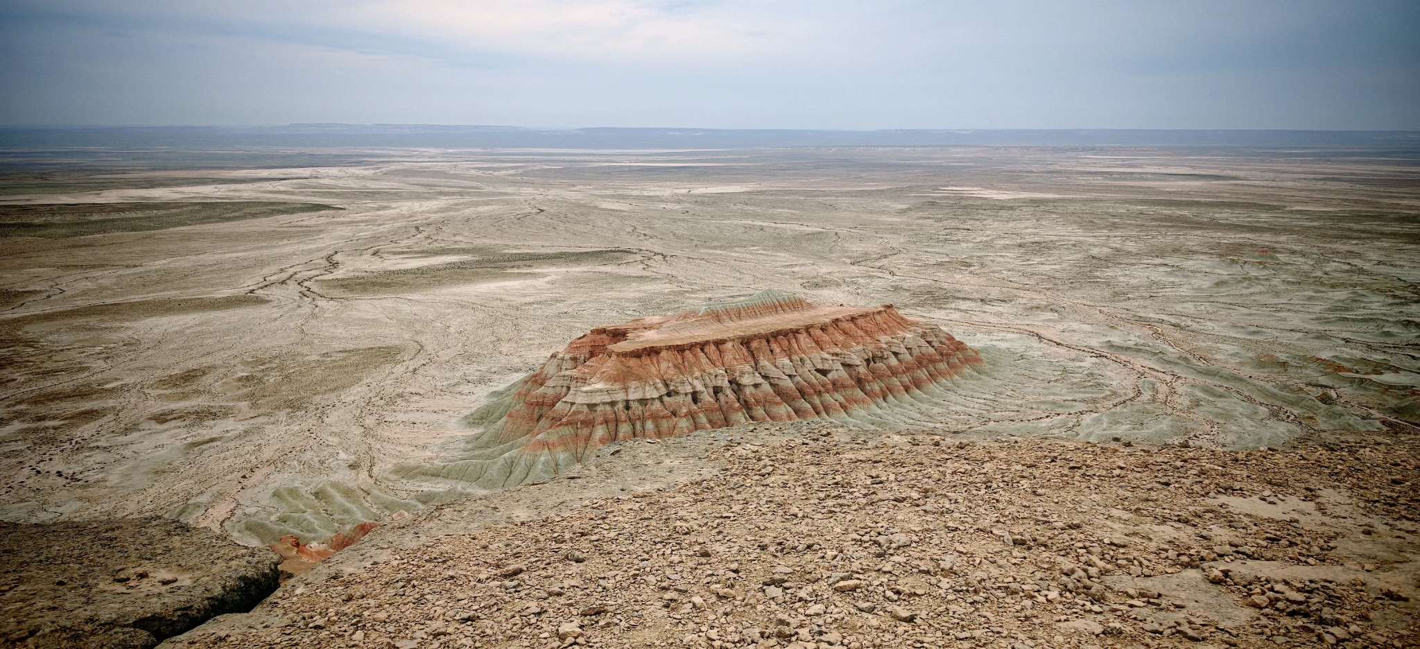 Panoramic View of Yangykala Canyon, Turkmenistan Panoramic view of the red, pink and white layered rock formations of Yangykala Canyon in the remote desert of Turkmenistan