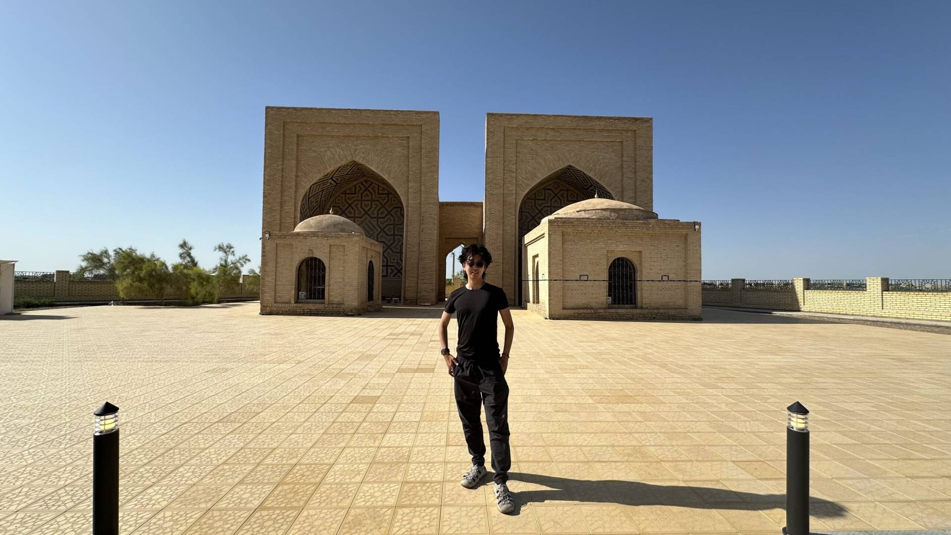 Japanese tourist visiting the historic Yusuf Hamadani Mosque and Mausoleum complex in Ancient Merv, Turkmenistan