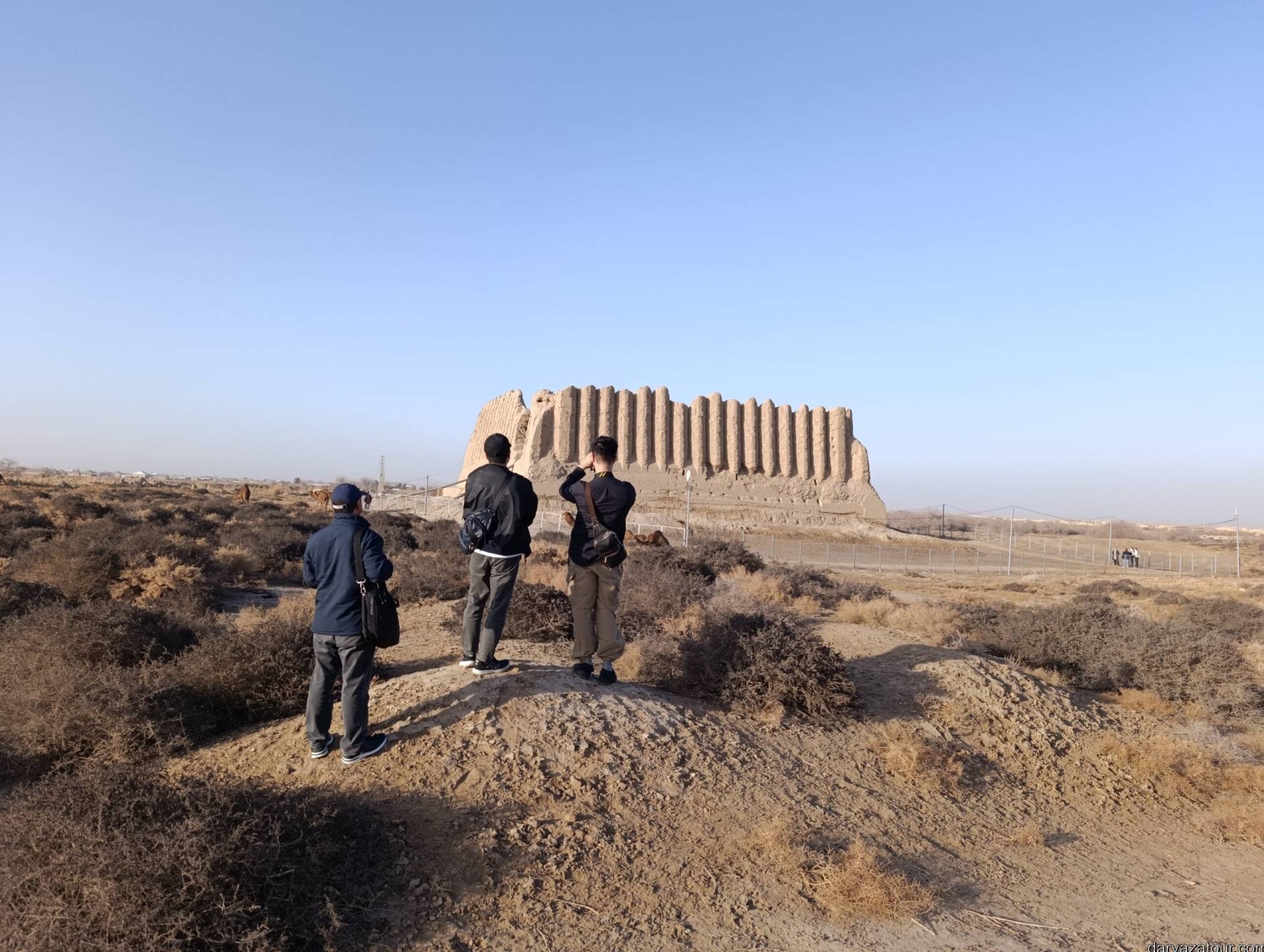Japanese tourists with their Japanese-speaking guide exploring the Great Kyz Kala ruins in Ancient Merv, Turkmenistan