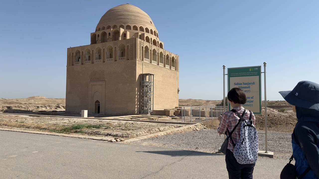 Travellers viewing the domed Mausoleum of Sultan Sanjar in Ancient Merv